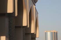 Picture of Dubai architecture (United Arab Emirates): Arched facade of mosque with modern skyscraper in the background