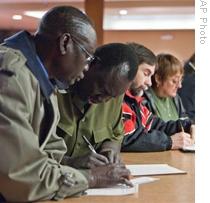 Job seekers fill out paperwork at a job fair in Omaha, Nebraska