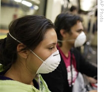 A woman from Mexico City and her Spanish friend wear face masks after arriving in Madrid on Tuesday