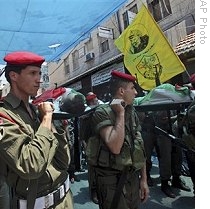 Palestinian security officers carry the two bodies of security officers killed during a shootout with members of Hamas in the West Bank city of Qalqilya, 31 May 2009