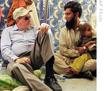 US envoy Richard Holbrooke (L) talks to a displaced man at Chota Lahore refugee camp in northwest Pakistan,04 Jun 2009