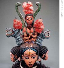 A wooden headpiece from Sierra Leone showing forms inspired by Mami Wata