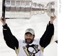 Pittsburgh Penguins' Bill Guerin raises the Stanley Cup after the Penguins won the National Hockey League championship in June