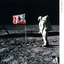 Edwin 'Buzz' Aldrin stands by an American flag on the moon