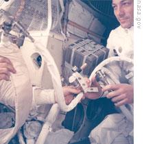 John Swigert holds the device that would clean carbon dioxide from the air in the lunar module