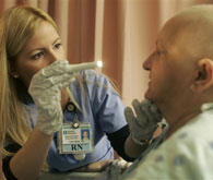 Nurse Yaima Milian examines a patient at Baptist Health of South Florida in Miami