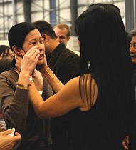 Journalist Laura Ling cries as she talks with sister/journalist Lisa Ling after arriving at Hangar 25 in Burbank, California, 05 Aug 2009