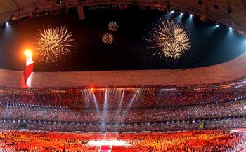 Fireworks go off after the torch is lit during the Opening Ceremony for the 2008 Beijing Summer Olympics at the National Stadium on August 8, 2008 in Beijing, China. (Photo credit: Alexander Hassenstein/Bongarts/Getty Images)