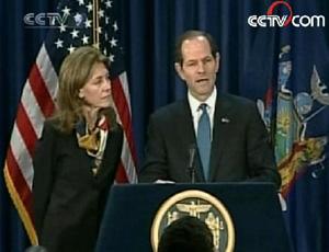 Spitzer read a minute-long statement at a news conference with his wife at his side.