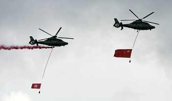 Helicopters with the Chinese national flag (R) and the flag of the Hong Kong Special Administrative Region (HKSAR) fly over the Golden Bauhinia Square during the flag raising ceremony to mark the 11th anniversary of Hong Kong's return to the Motherland in Hong Kong, China, July 1, 2008.(Xinhua Photo)