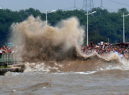 People watch tidal waves along Qiantang River