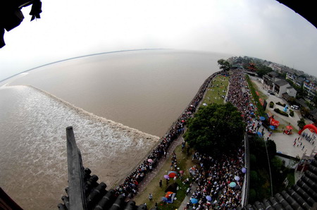 People watch tidal waves along Qiantang River
